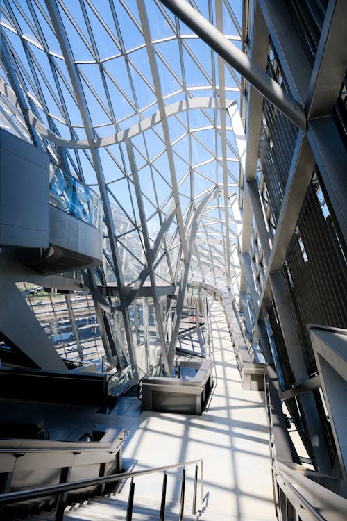 A Glass Roof and Ceiling Building with Metal Frames Under Blue Sky