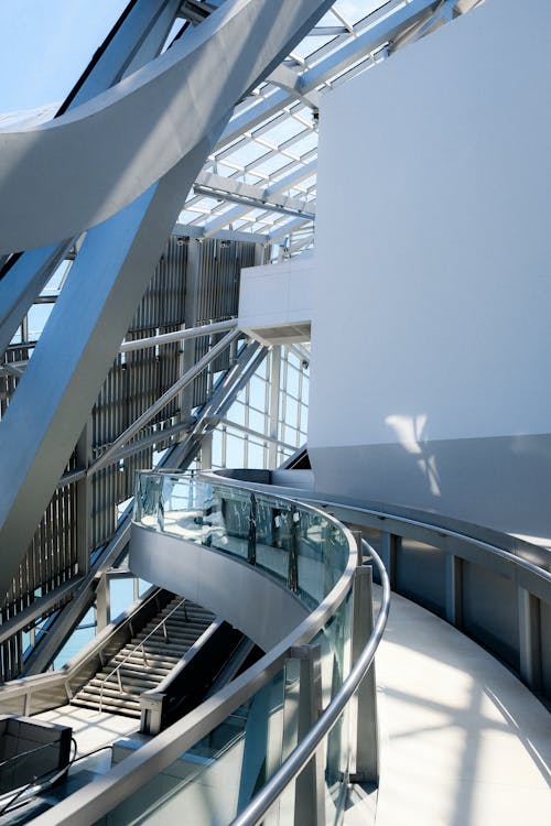 A Glass Ceiling Building with Metal Frame Inside and Concrete Ramp with Metal Railings