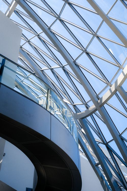 Free Elegant modern architecture featuring a curved glass ceiling with metal framing. Stock Photo