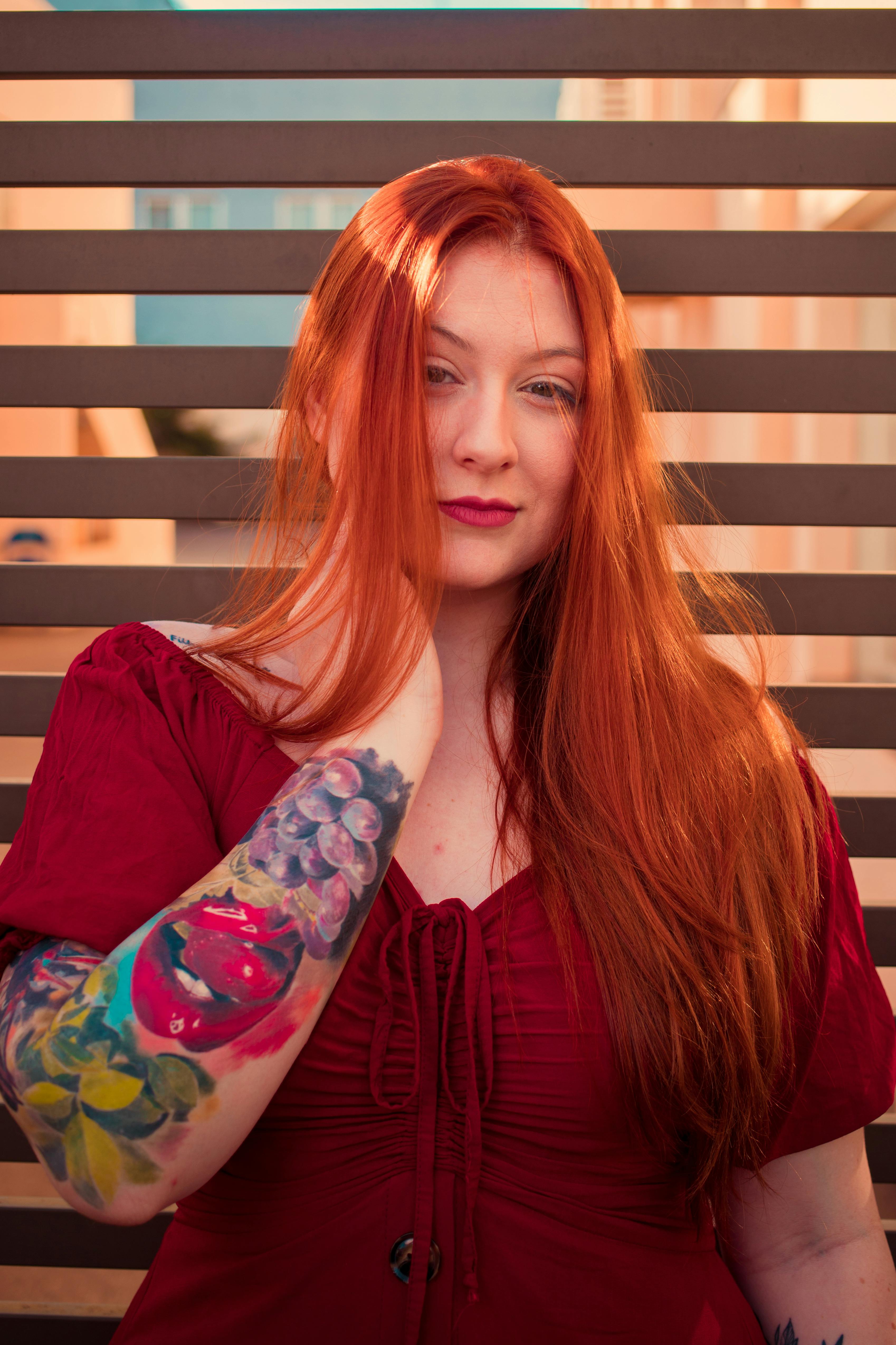 young redhead woman with tattoos