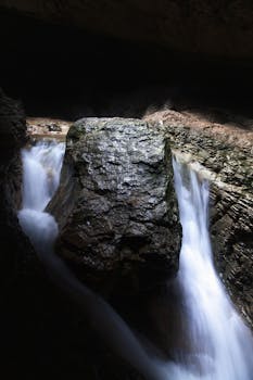 Stunning waterfall cascading over rock formations in a cave, Dagestan, Russia.