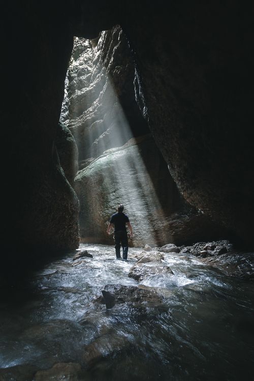 Free A man stands in a sunlit cave in Dagestan, Russia, highlighting geological wonders. Stock Photo