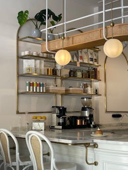 Inviting coffee shop interior showcasing modern design with shelves, lamps, and furniture.