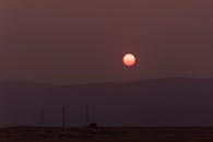 日落戏剧性地映衬着山脉的剪影，天空充满活力