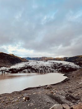 Explore the stunning Sólheimajökull Glacier, nestled in Iceland's serene landscape.