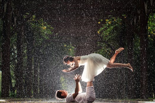 Creative rain-soaked wedding photoshoot featuring a couple in an artistic pose outdoors.