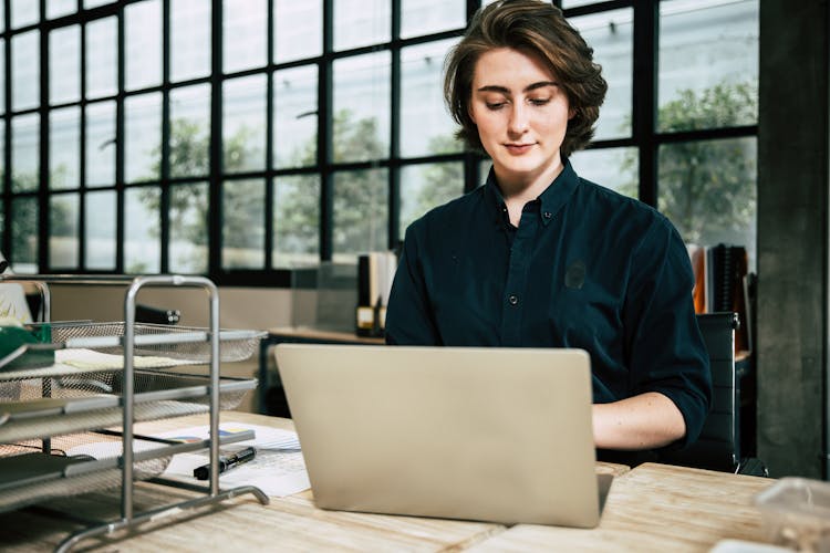 A Pretty Woman In Black Long Sleeve Blouse Using Laptop
