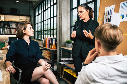 Free Diverse colleagues collaborative brainstorming at office briefing. Business woman manager explaining analysis at the meeting startup work. Stock Photo