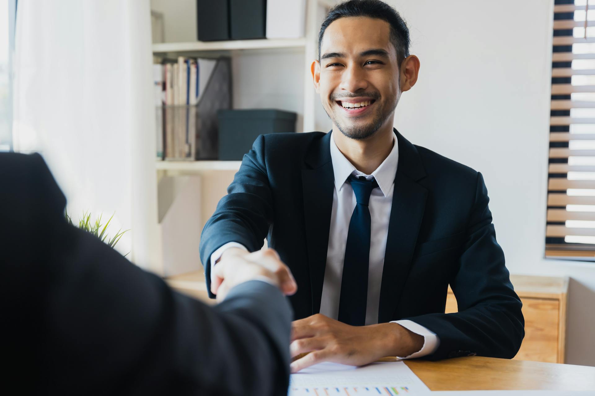 successful negotiate and handshake concept, two businessman shake hand with partner to celebration partnership and teamwork, business deal