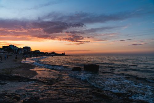 Free A tranquil sunset view over Cabo Negro beach, capturing the vibrant hues of the evening sky and serene ocean waves. Stock Photo