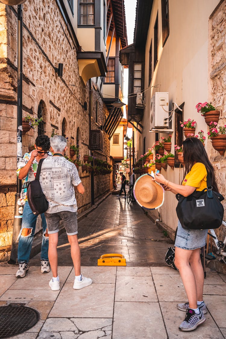 Tourist On A City Street Checking A Road On A Map