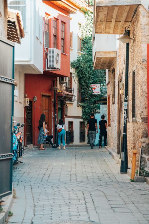 Free Explore a vibrant cobblestone street filled with pedestrians in an urban setting. Stock Photo