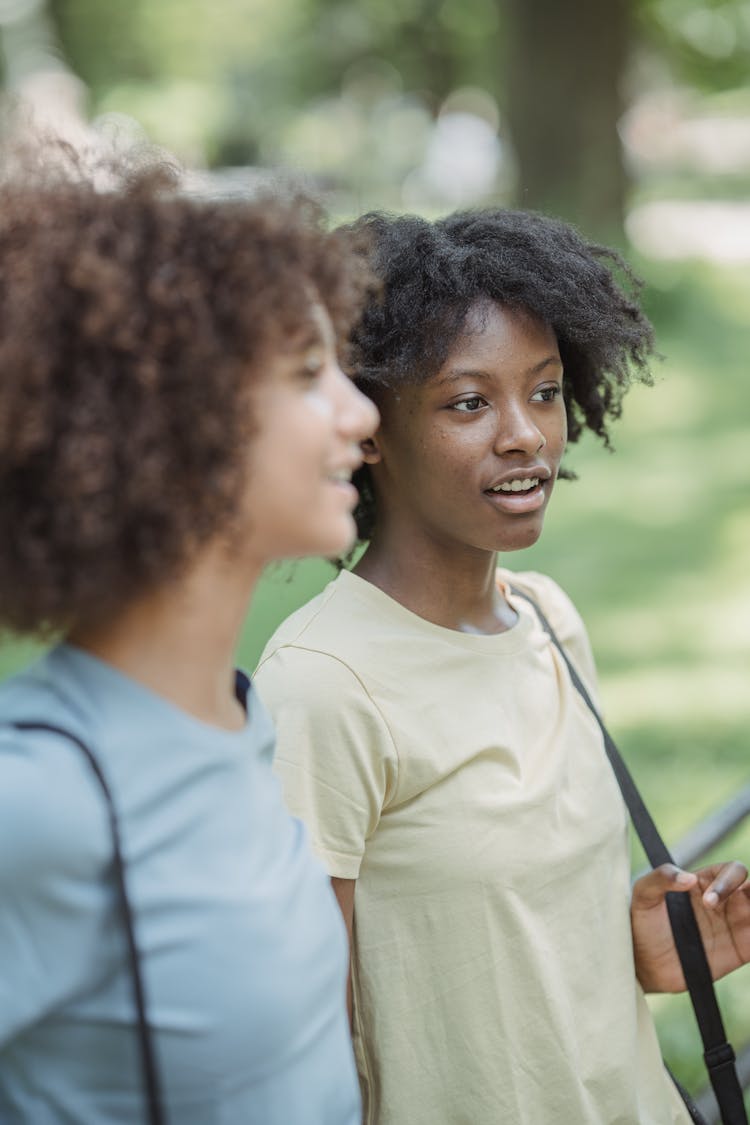 Two Teenage Girls With Afro Curly Hair Talking