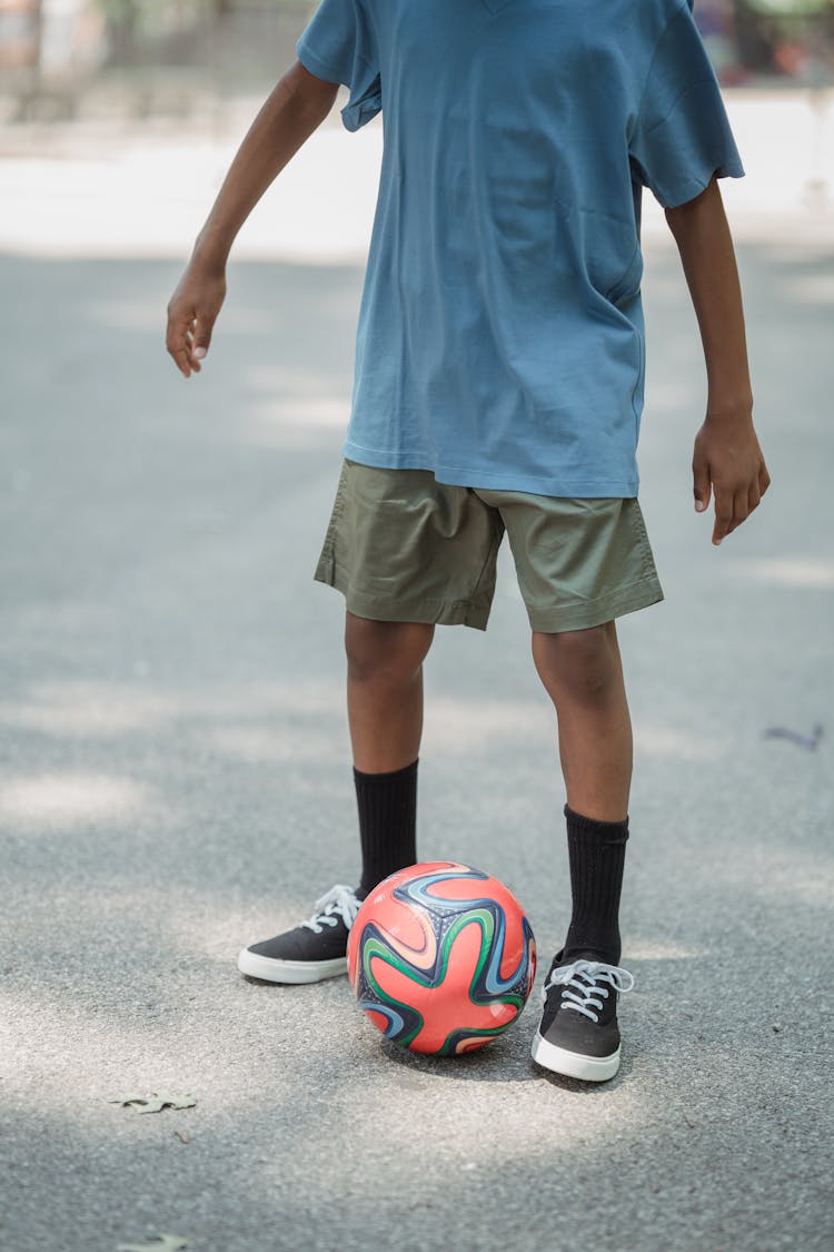 Boy Playing With A Ball