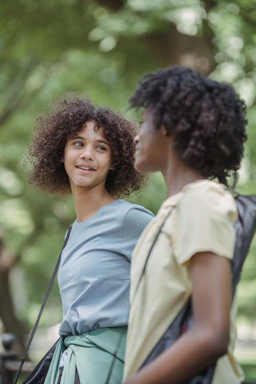 Two Friends Talking on Walk in Park