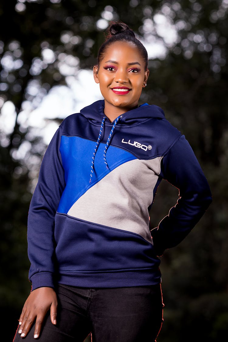 Photo Of A Standing Smiling Woman Dressed In A Sportswear