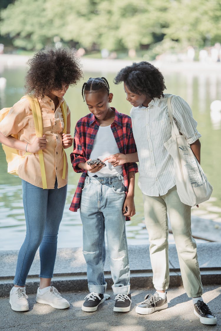 Women And Boy Looking At Phone