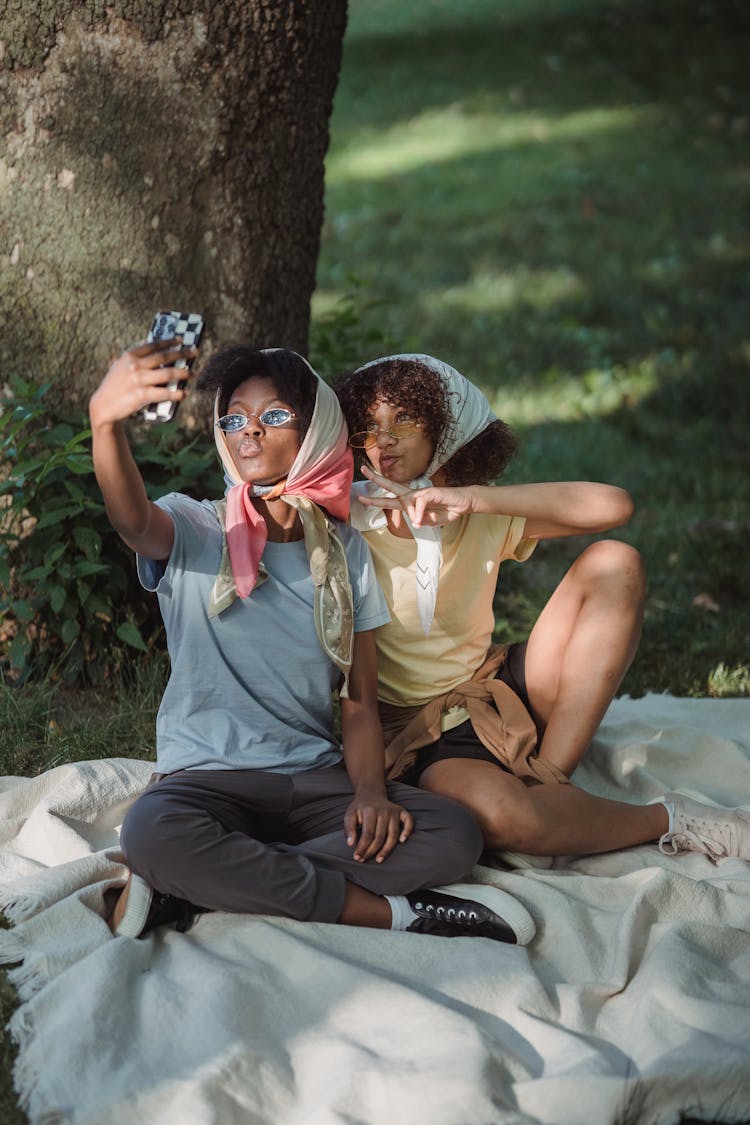 Mother And Child Taking Selfie In Park