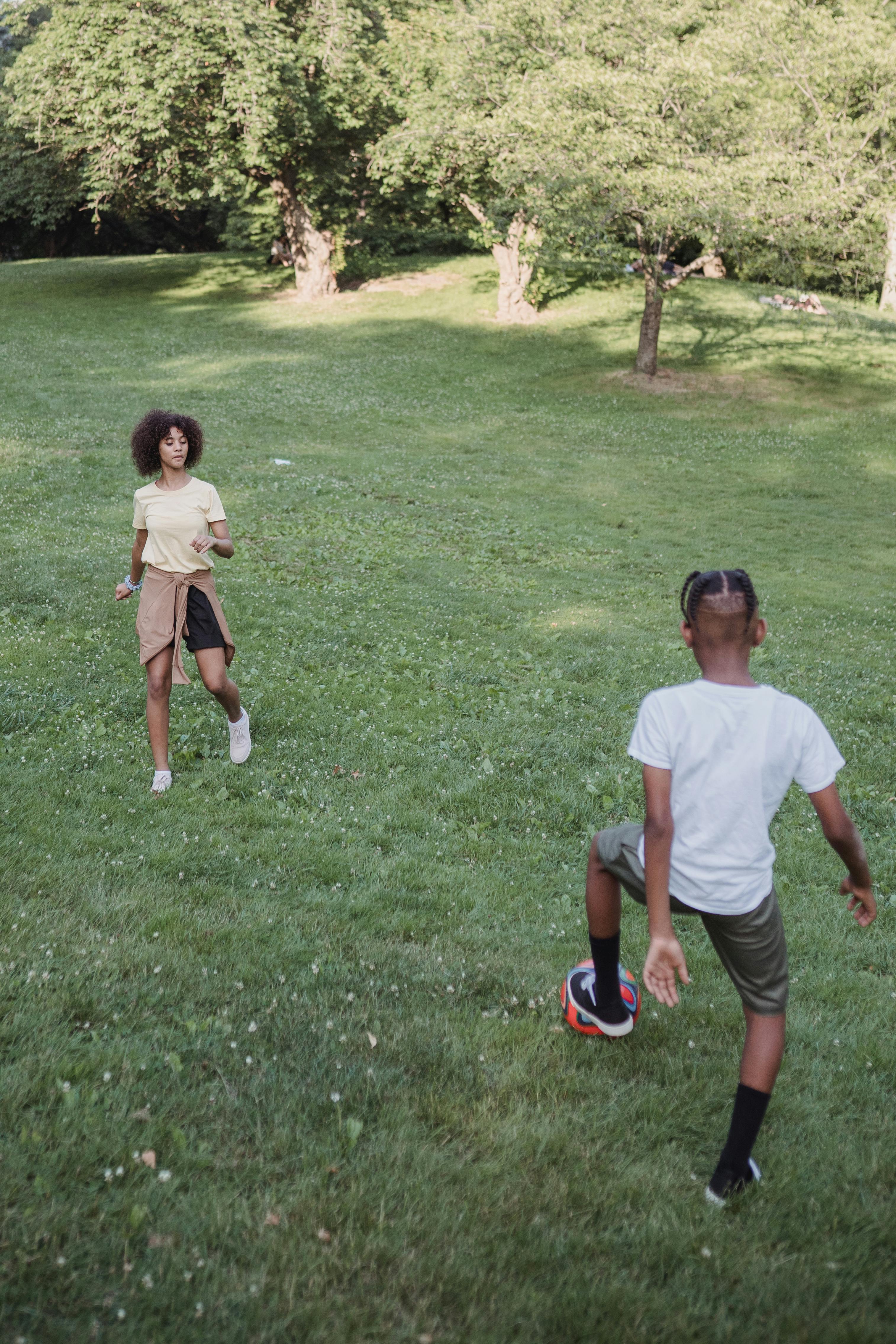 children playing football in park