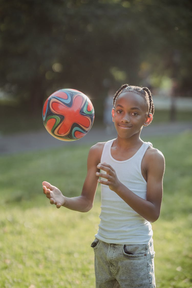 Boy Tossing The Ball In The Air 