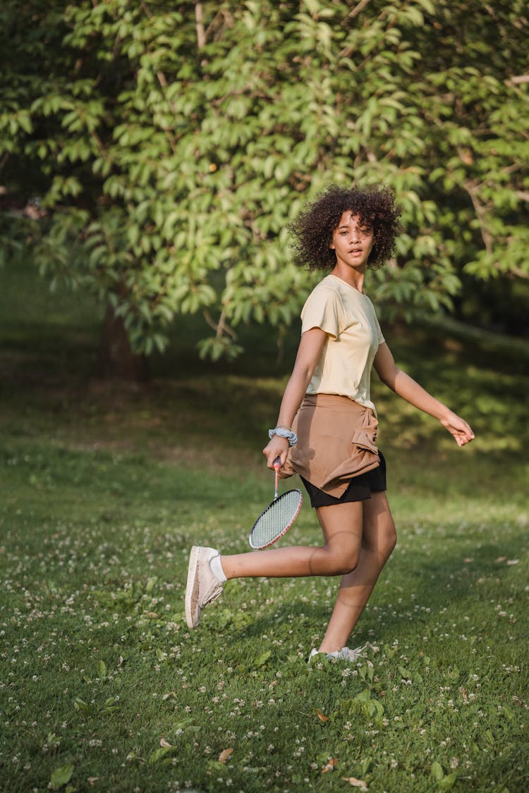 Girl Playing Badminton In Park