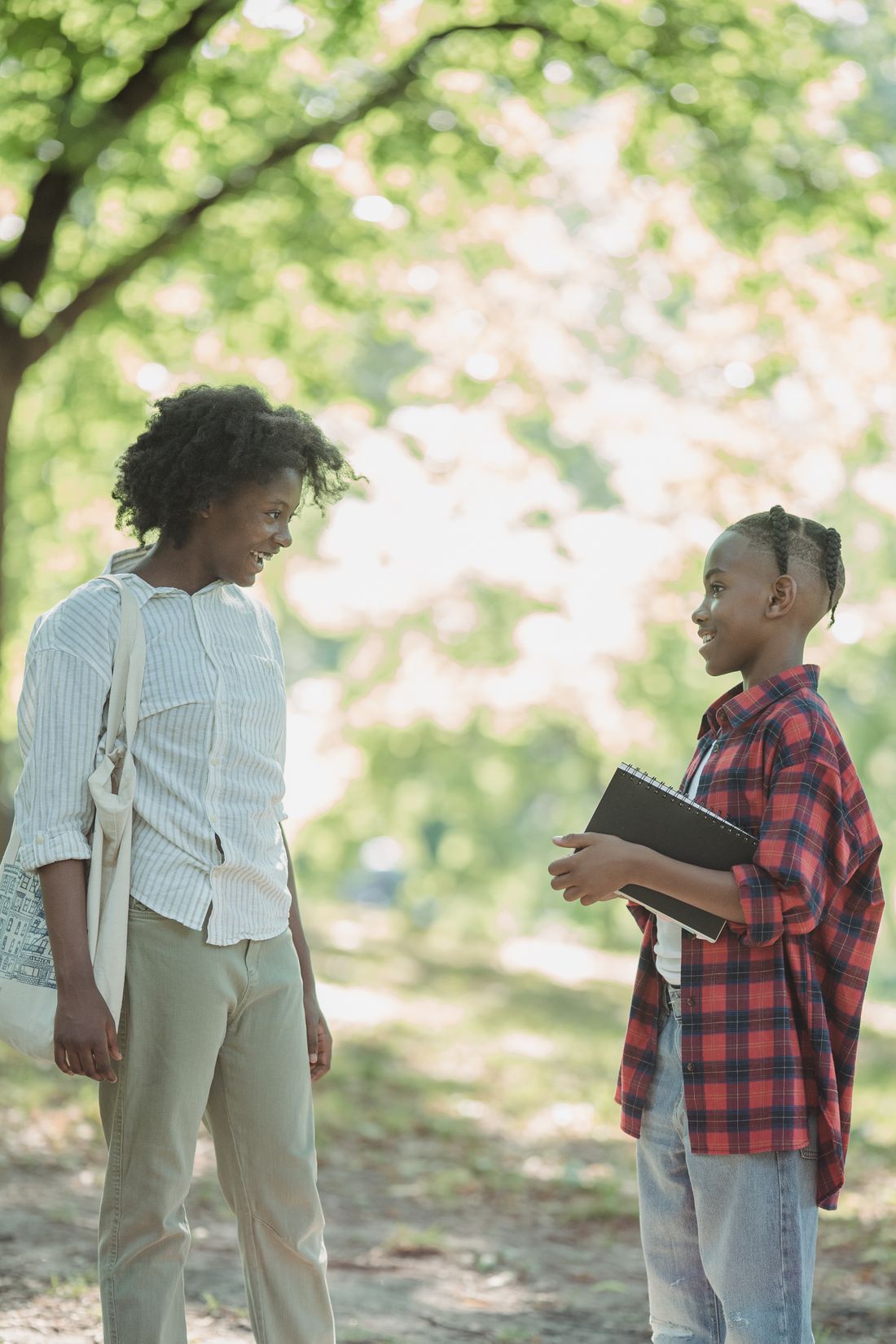 A mentor talking with a young person outdoors