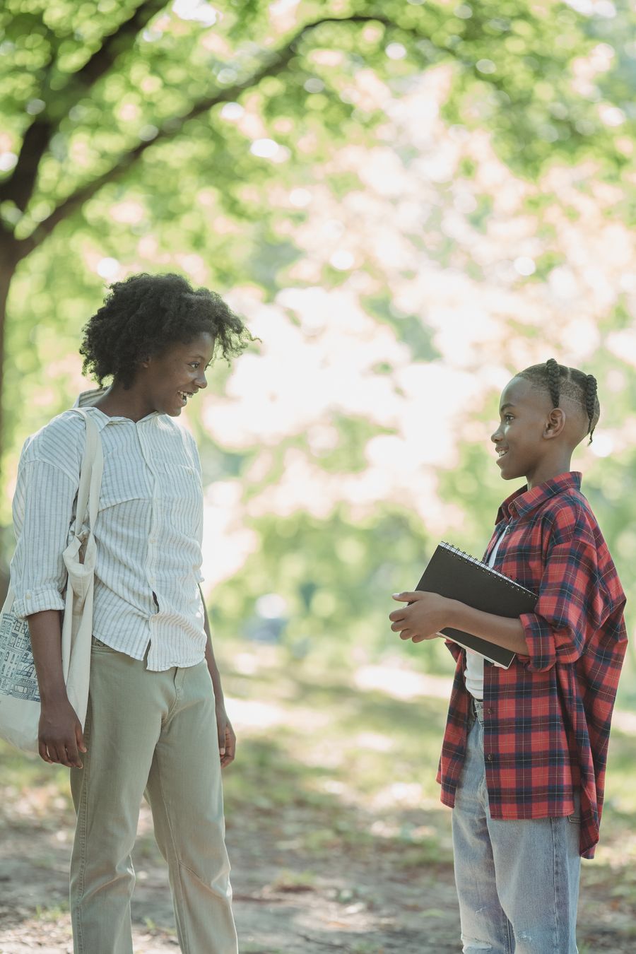 A mentor talking with a young person outdoors