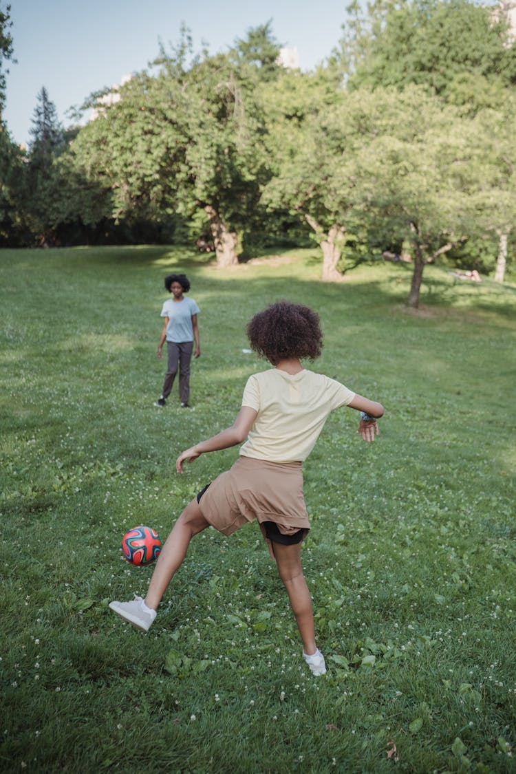 Women Playing Football In A Park