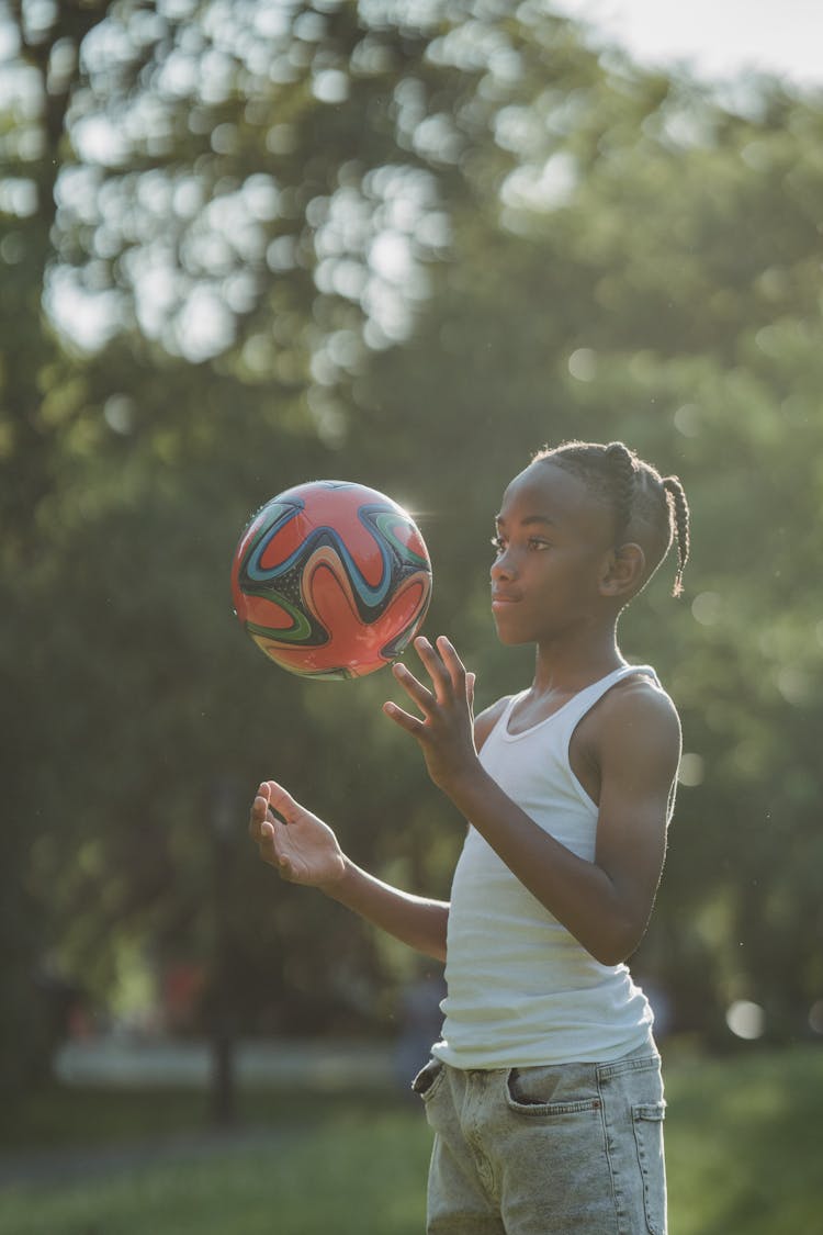 Young Boy Tossing A Football Ball 