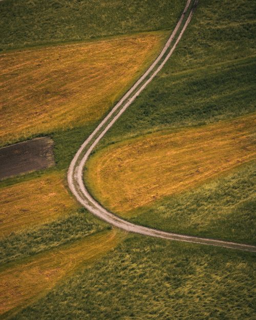 Free Aerial view of fields with winding paths in the picturesque countryside of Tirol, Austria. Stock Photo