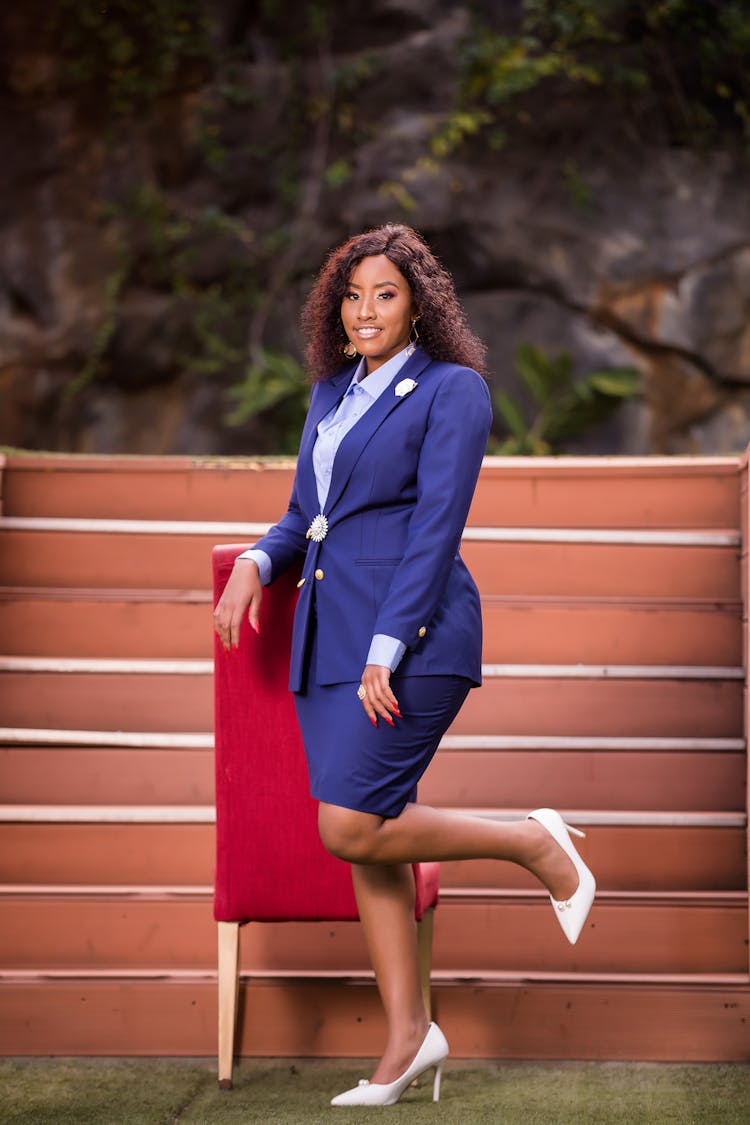 Woman In Suit Posing By Chair