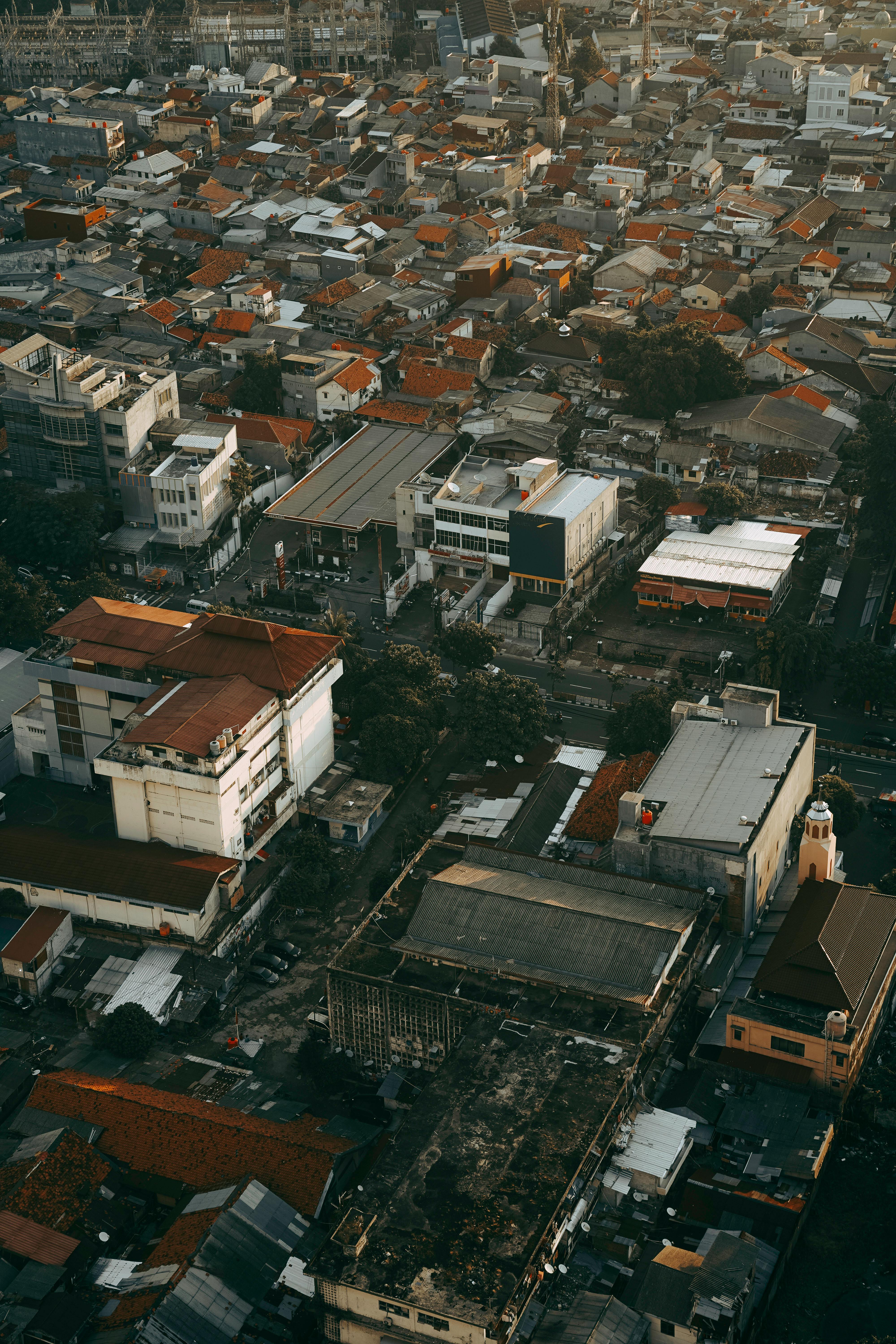 Aerial perspective of a densely populated urban area showcasing rooftops and buildings in an atmospheric setting.