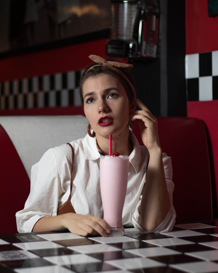 A Woman With A Strawberry Milkshake