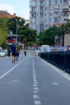City street view with people walking and urban buildings, showcasing daily life.
