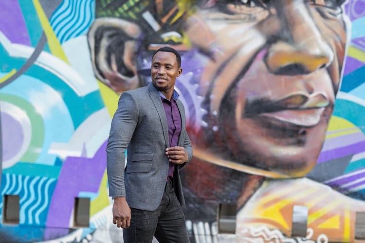 Smiling Man In Suit And Graffiti On Wall Behind