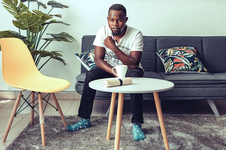 A Man In White Shirt Siting On The Couch