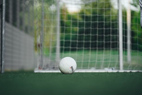 White Soccer Ball on Green Field