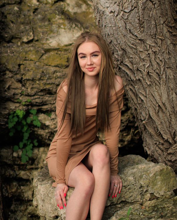 A Woman in Brown Long Sleeve Dress Sitting on Rock · Free Stock Photo