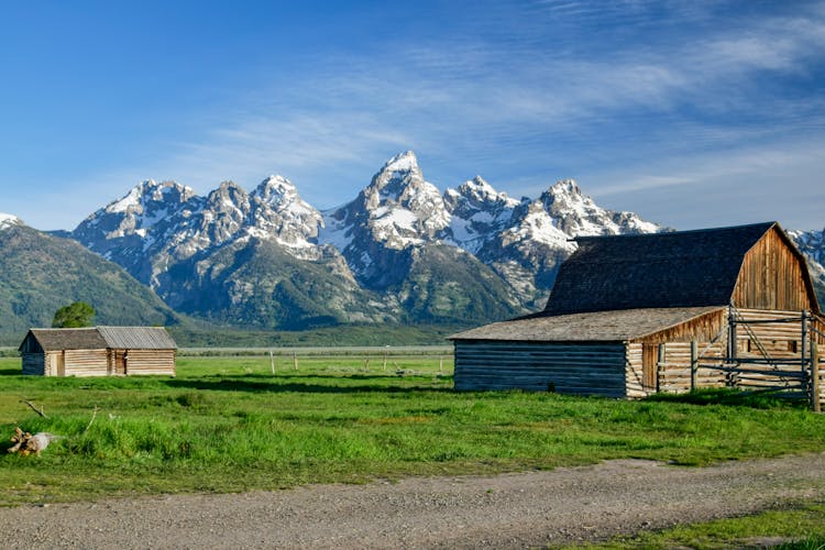 A Brown Wooden House Near The Teton Mountain  Range In Wyoming, United States