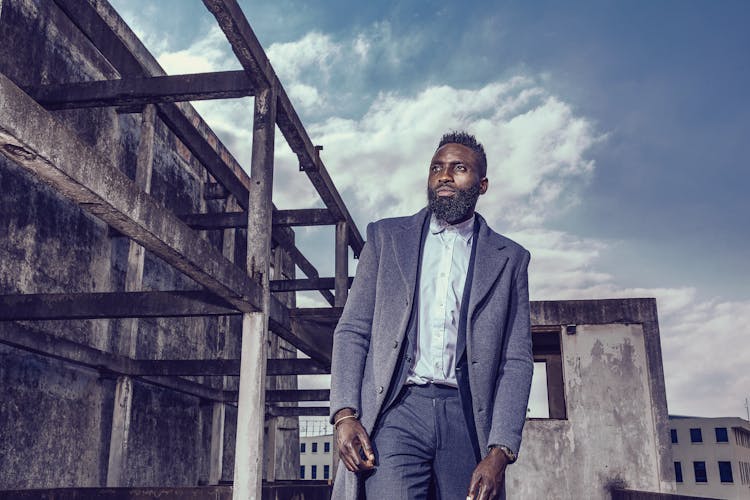 Elegant Man Wearing A Suit And Coat 