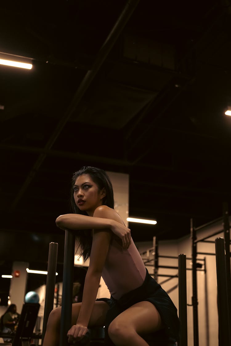 A Woman In Sitting On A Gym Equipment