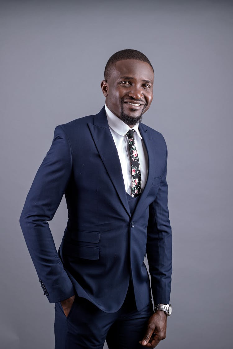 A Man Wearing A Navy Blue Suit And Watch