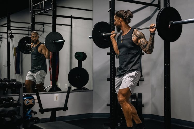 A Man Lifting Weights In The Gym