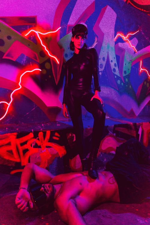 Free Edgy urban portrait featuring leather fashion against vibrant graffiti. Stock Photo