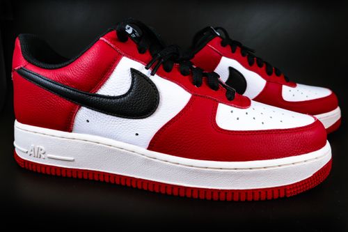 Free Close-up of stylish red and white sneakers with black swoosh, ideal for fashion and sportswear enthusiasts. Stock Photo