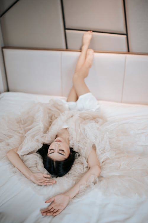 Woman in Negligee Lying in Bed
