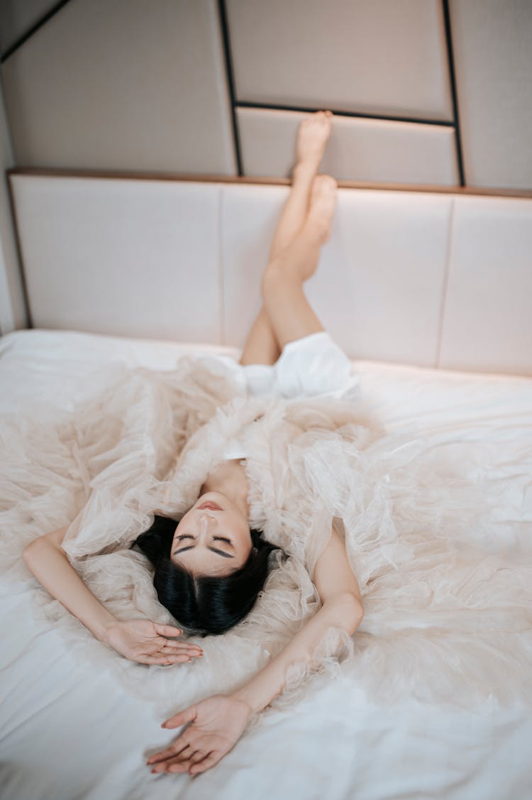 Woman In Negligee Lying In Bed