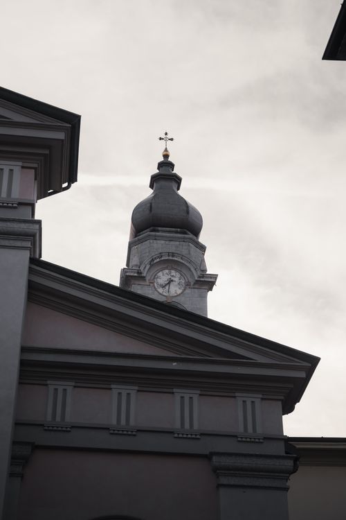 Free A serene view of a classic church bell tower in Menaggio, Lombardy, Italy. Stock Photo