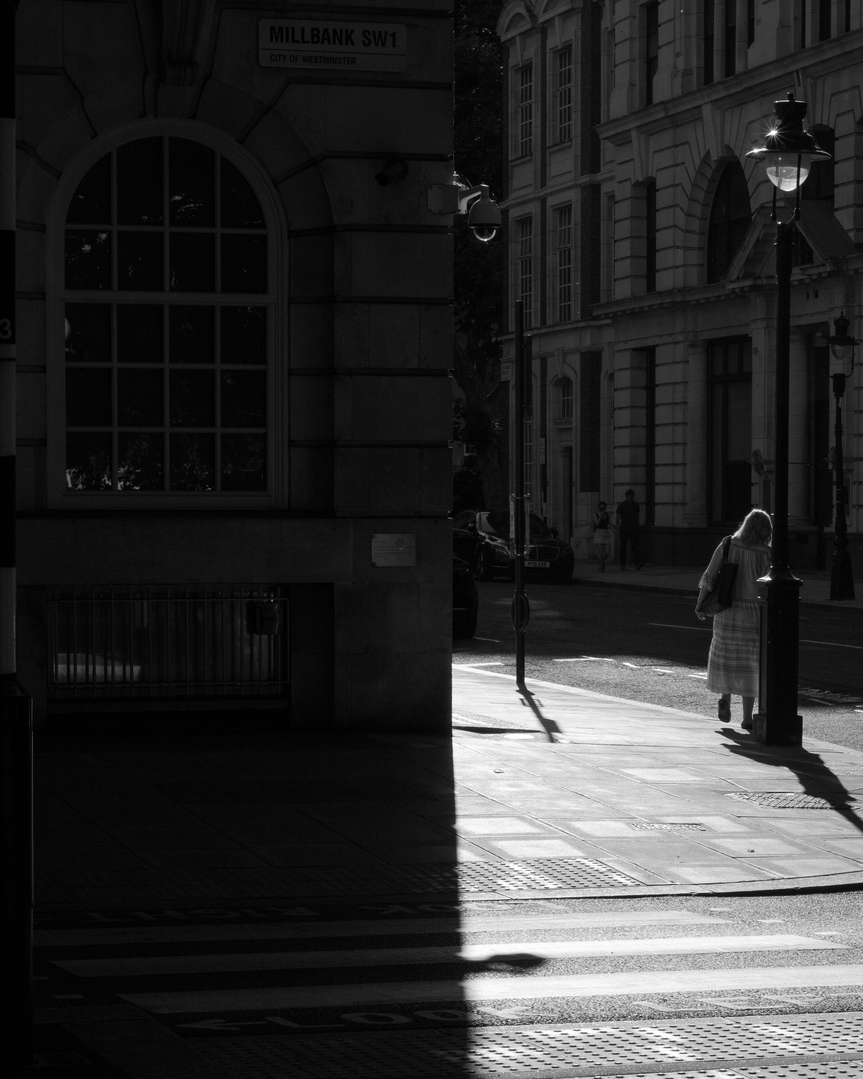 Grayscale Photo of Woman Standing on the Street · Free Stock Photo
