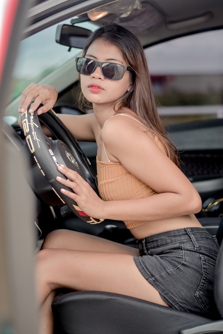 Photo Of A Girl With Black Sunglasses Driving